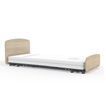 The Accora Empresa® Full Electric Bariatric FloorBed® combines a low-profile design with light wood headboard and footboard, a white mattress, and visible wheels for easy mobility—ideal for facilities valuing both style and functionality.