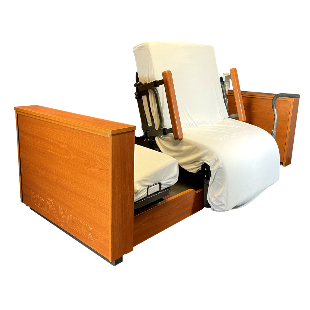 The Med-Mizer ActiveCare Rotating Hospital Bed features a wooden frame, white fabric covers, side armrests, and a mechanical lift for patient support and mobility—ideal for use with adjustable or hospital beds.