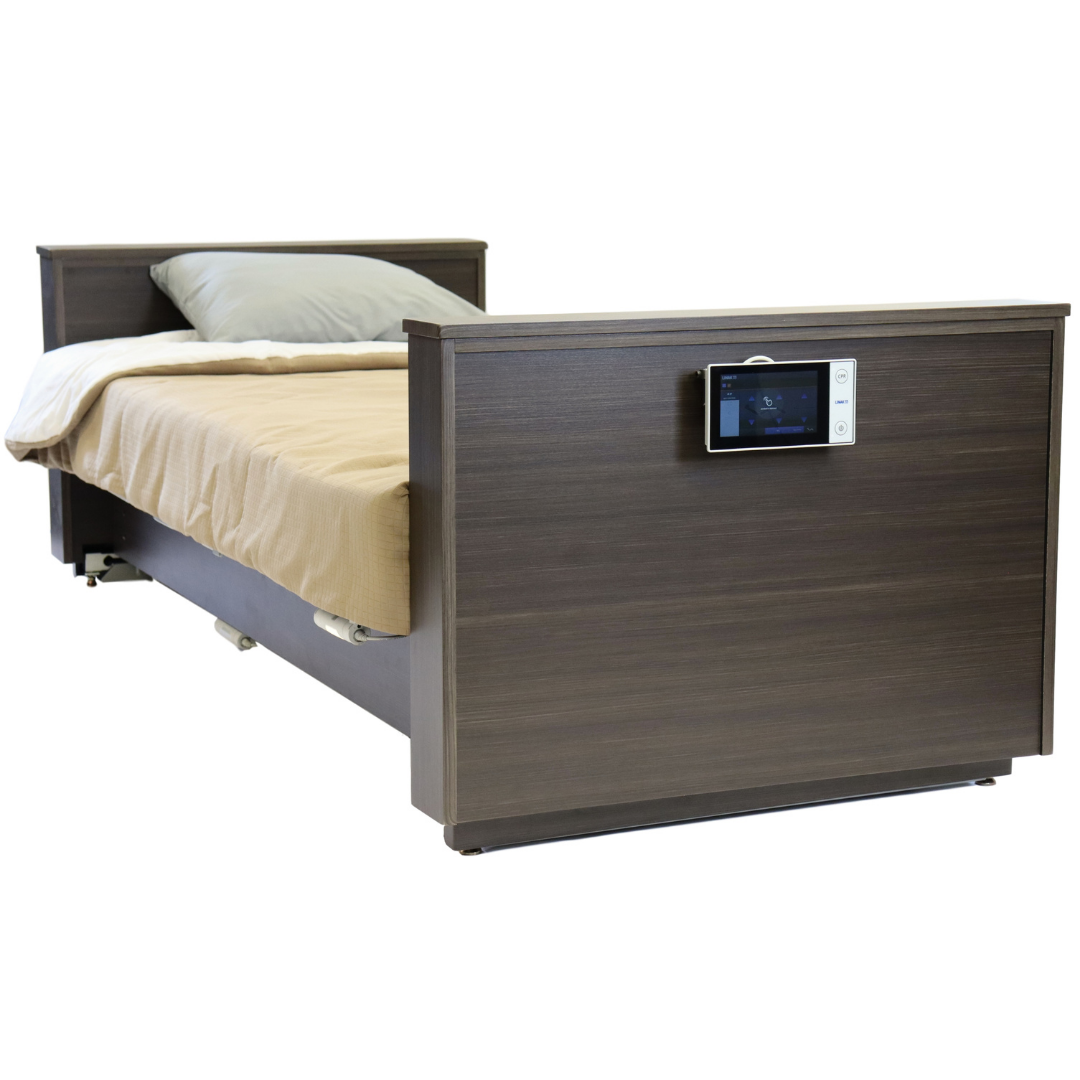 The Med-Mizer ActiveCare Rotating Hospital Bed features a brown wooden frame, beige bedding, a gray pillow, and an electronic control panel on the footboard.