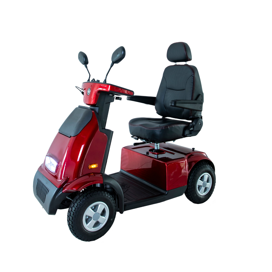 The Afikim Afiscooter C4 HD 4-Wheel Mobility Scooter is a versatile red scooter featuring a padded seat, armrests, and handlebars. Its four-wheel base and front light make it stand out elegantly against a plain white background.