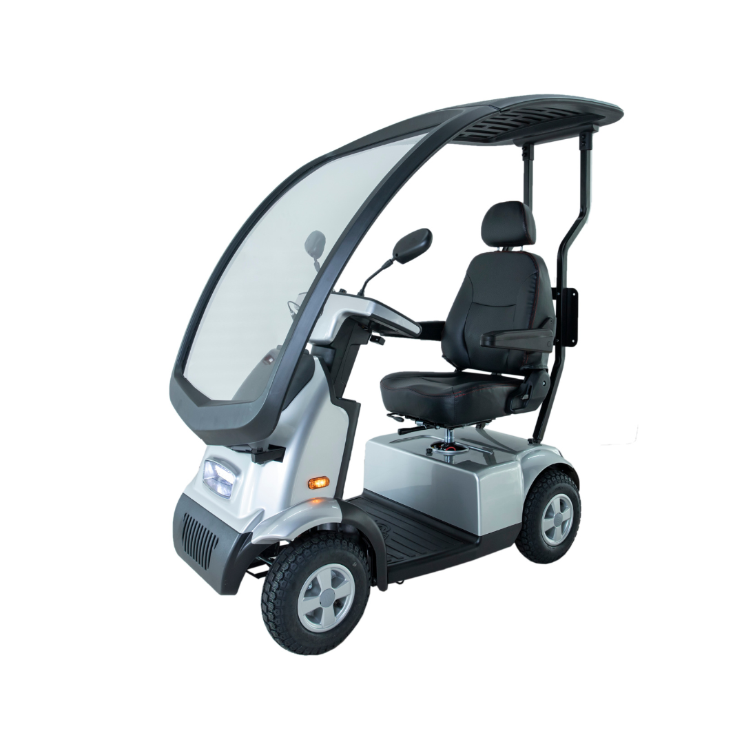 The Afikim Afiscooter C4 HD is a silver 4-wheel electric mobility scooter with an orthopedic seat, overhead canopy, two rearview mirrors, and a clear front windscreen for protection.