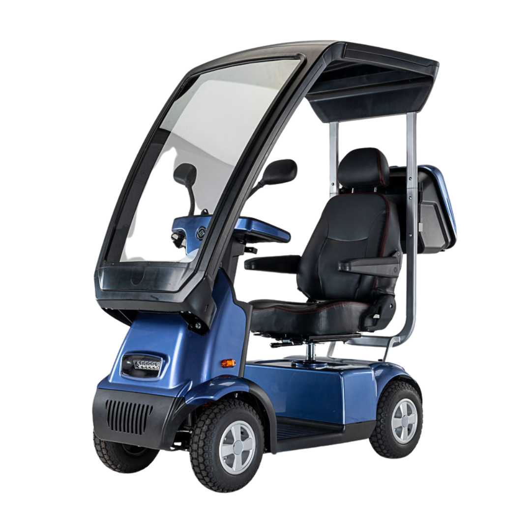 The Afikim Afiscooter C4 HD is a blue four-wheel electric mobility scooter with an enclosed canopy, orthopedic padded seat, and steering controls, offering a blend of functionality and comfort while protecting from weather elements.