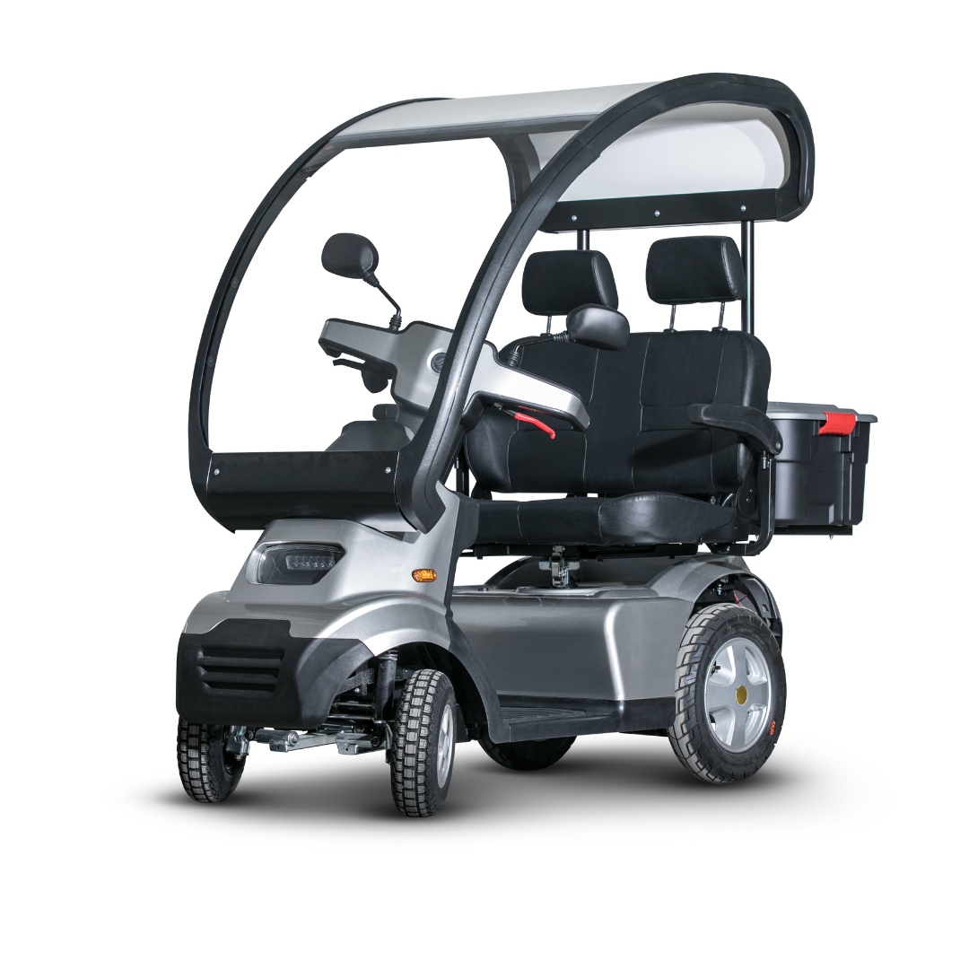 The Afikim Afiscooter S4 HD Bariatric Mobility Scooter features a sleek, covered black and gray design equipped with a transparent canopy, rearview mirrors, and dual seating with armrests, providing comfort for two. Its large wheels ensure stable all-terrain performance for outdoor adventures.