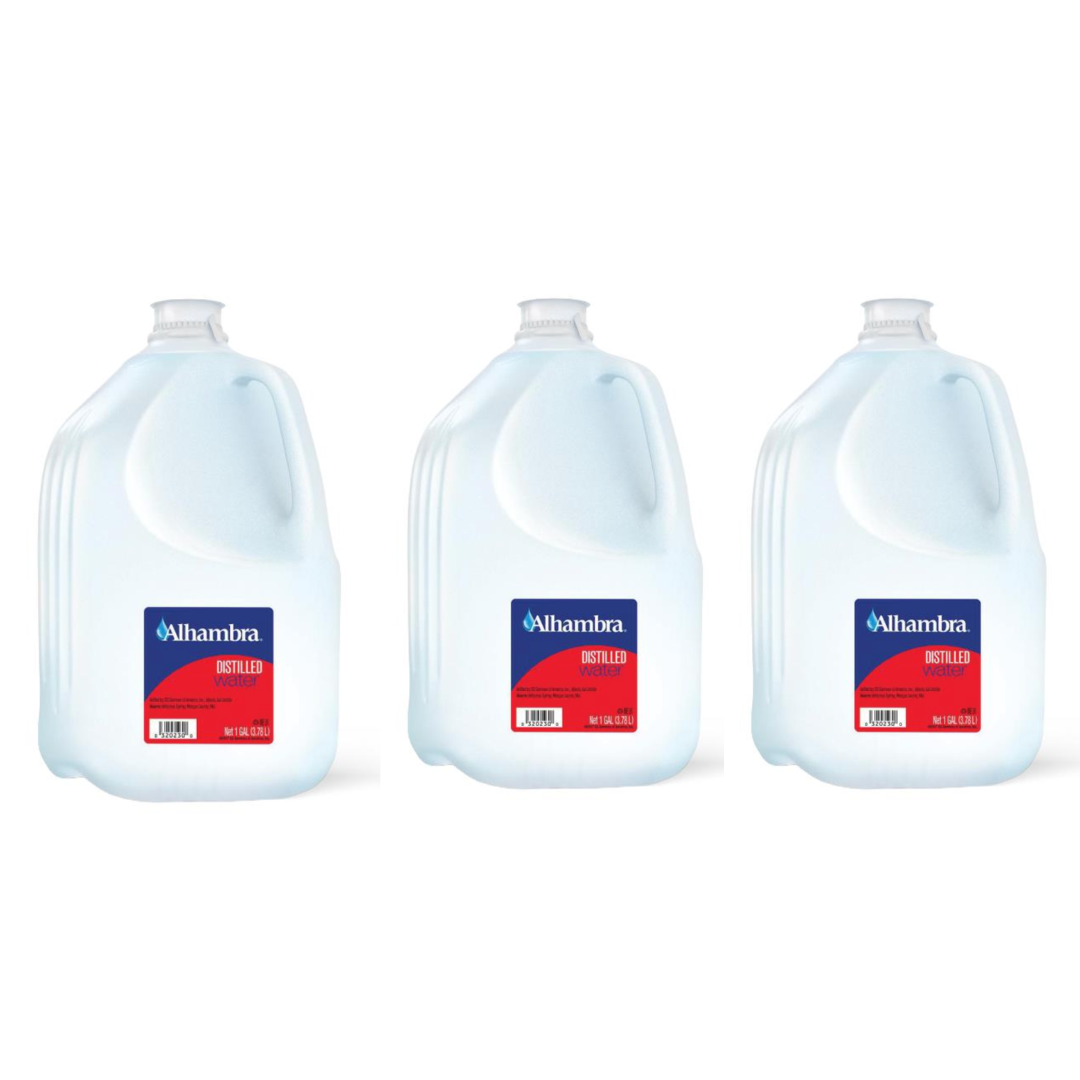 Three 1-gallon jugs of Alhambra Distilled Water with blue and red labels are lined up against a white background. A convenient hydration choice from WATER SOURCE ONE.