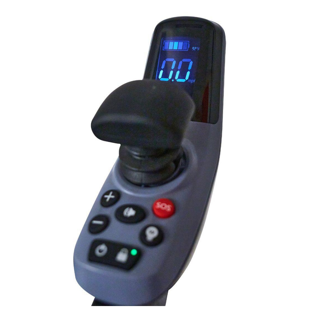 Close-up of a Golden Tech Ally Sport Smart Powerchair joystick panel with omni-directional control, speed and battery indicators, various buttons including a red SOS button, and a digital display reading 0.0 mph.