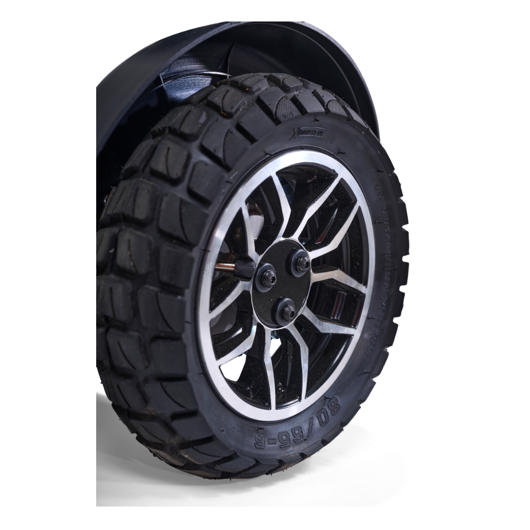 Close-up of a rugged black rubber tire with a silver and black alloy wheel on the Golden Tech Ally Sport Smart Powerchair with Omni-Directional Wheels and App Control, highlighting its deep treads and advanced off-road capability.