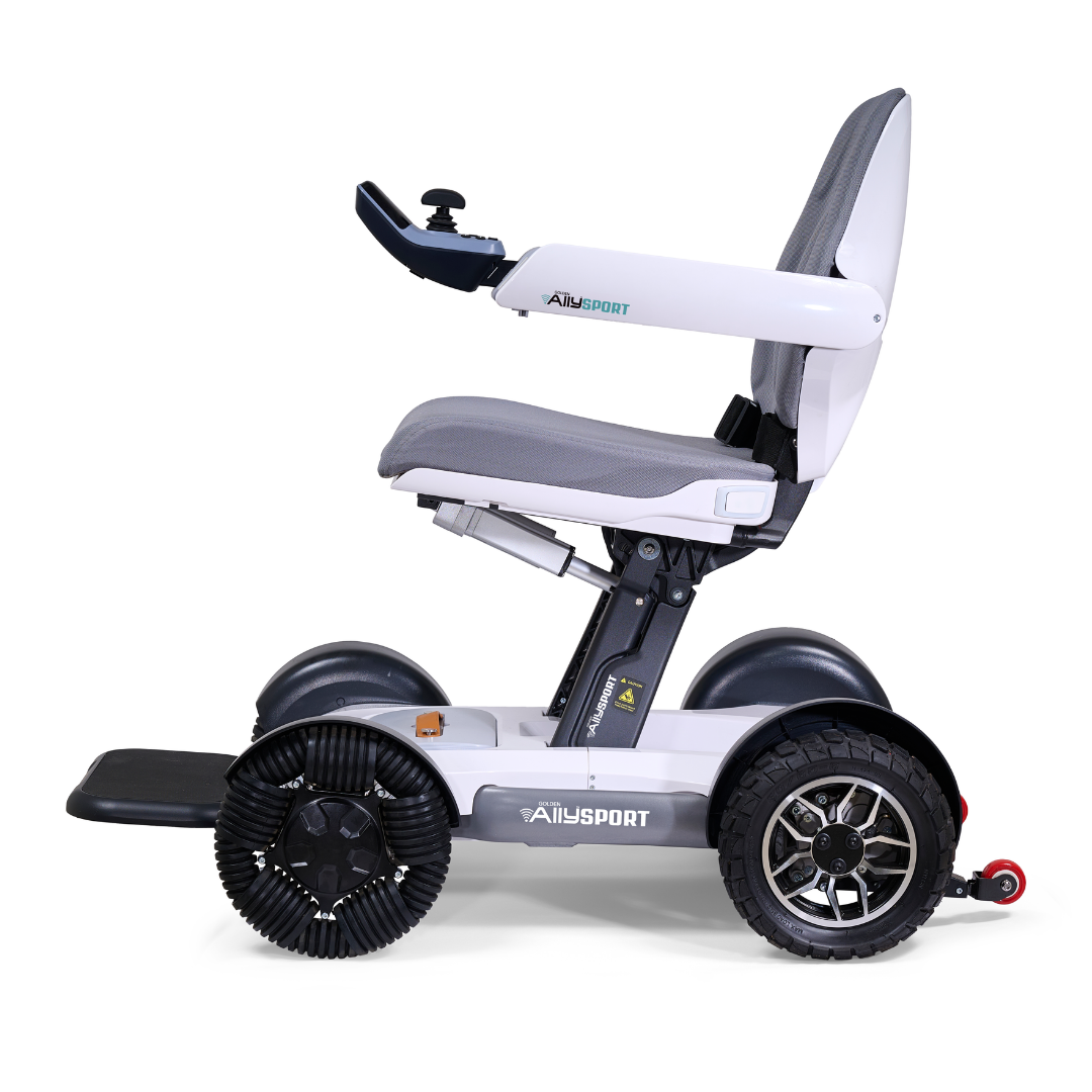 The Golden Tech Ally Sport Smart Powerchair, viewed from the side, features gray upholstery, large omni-directional wheels, app and joystick controls on the armrest, ergonomic memory foam seating, and the brand name on the base.