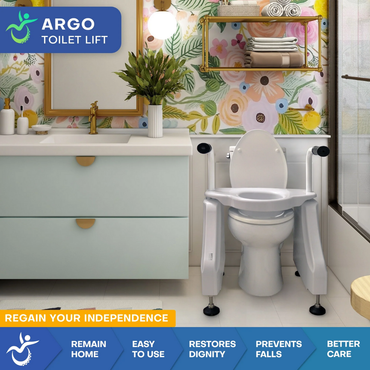 A modern bathroom showcases the ArGo Bariatric Electric Toilet Lift—an ergonomic seat with supportive arms. Colorful floral wallpaper and a flower vase add charm. The lift enhances bathroom safety, accessibility, and ease of use.