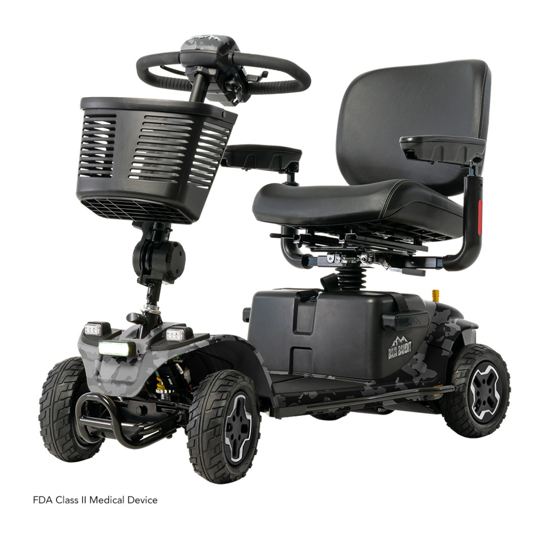 The Pride Baja® Bandit 4 Wheel Scooter, fitted with a cushioned seat, handlebars, and front basket, features four robust wheels for off-road trips. It has a black frame and camouflage lower section, powered by a lithium-ion battery. The text reads FDA Class II Medical Device.