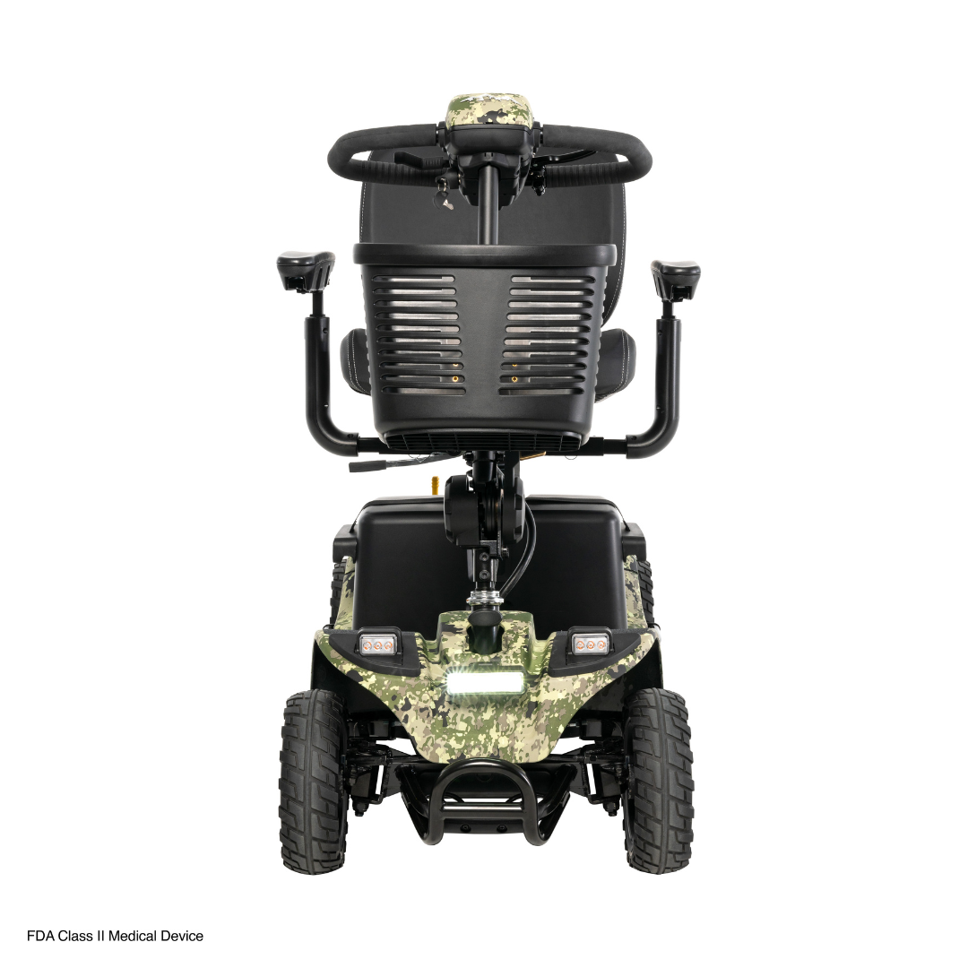 The front view of the Pride Baja® Bandit 4 Wheel Scooter showcases a camo-patterned design with cushioned black seat, armrests, tires, and handlebars. Designed for off-road adventures, it features rugged wheels and a sturdy frame with full suspension to handle rough terrain effortlessly.