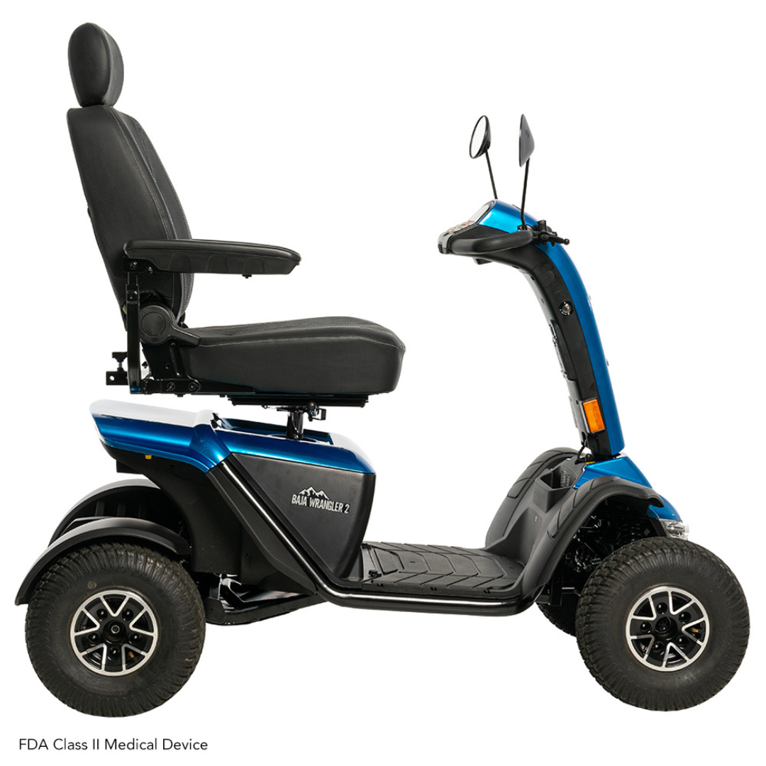 The Pride Baja® Wrangler® 2 Heavy Duty Outdoor Scooter, in blue, features a black seat, four wheels, rearview mirrors, and sturdy tires for rugged terrain. It ensures comfort and support for mobility needs and has visible FDA Class II medical device labeling.