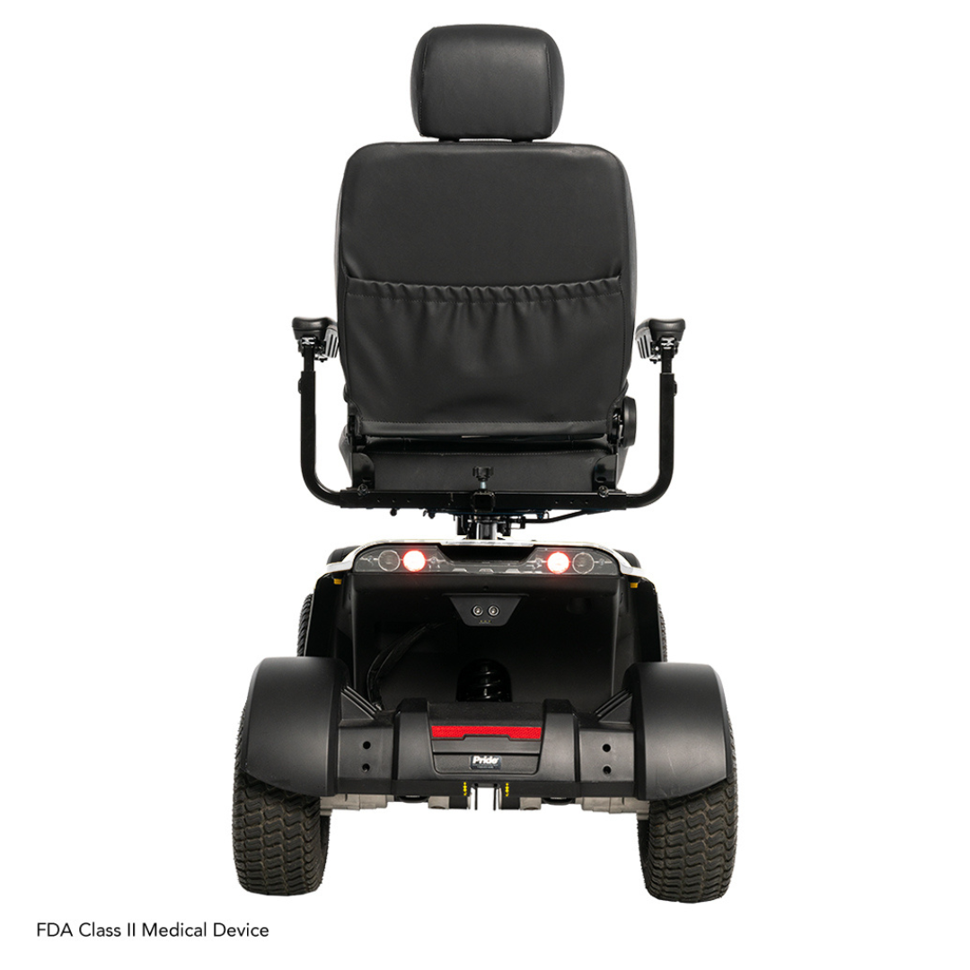 Rear view of the Pride Baja® Wrangler® 2 scooter showing a cushioned backrest, armrests, rear lights, and two sturdy wheels. It features CTS Suspension for a smooth ride and is labeled as an FDA Class II Medical Device in the bottom left corner.
