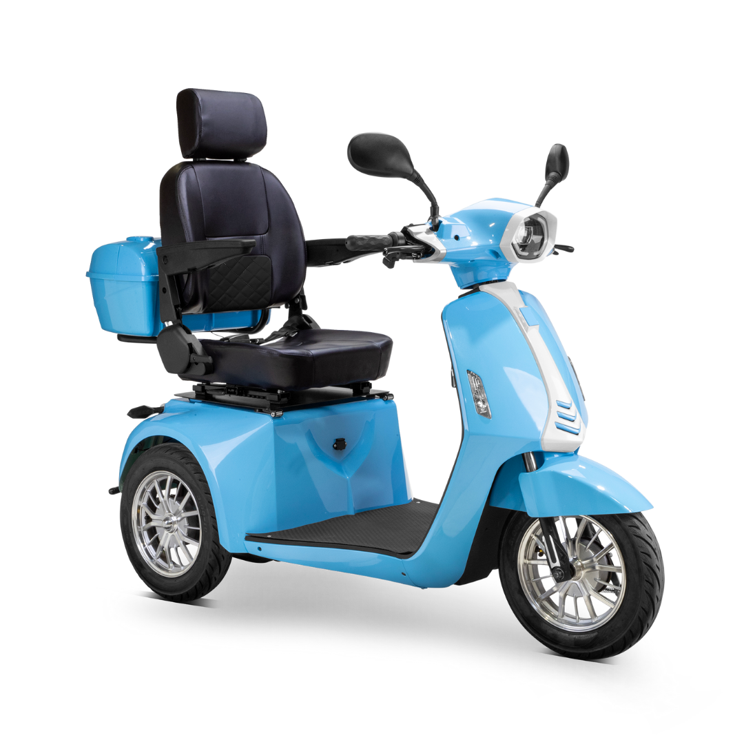 The Bespoke Elite Recreational 3-Wheel Scooter with Electric Brake Assist is light blue, features a high backrest, armrests, rear storage box, large wheels, and a digital speedometer—designed for comfortable personal transportation.