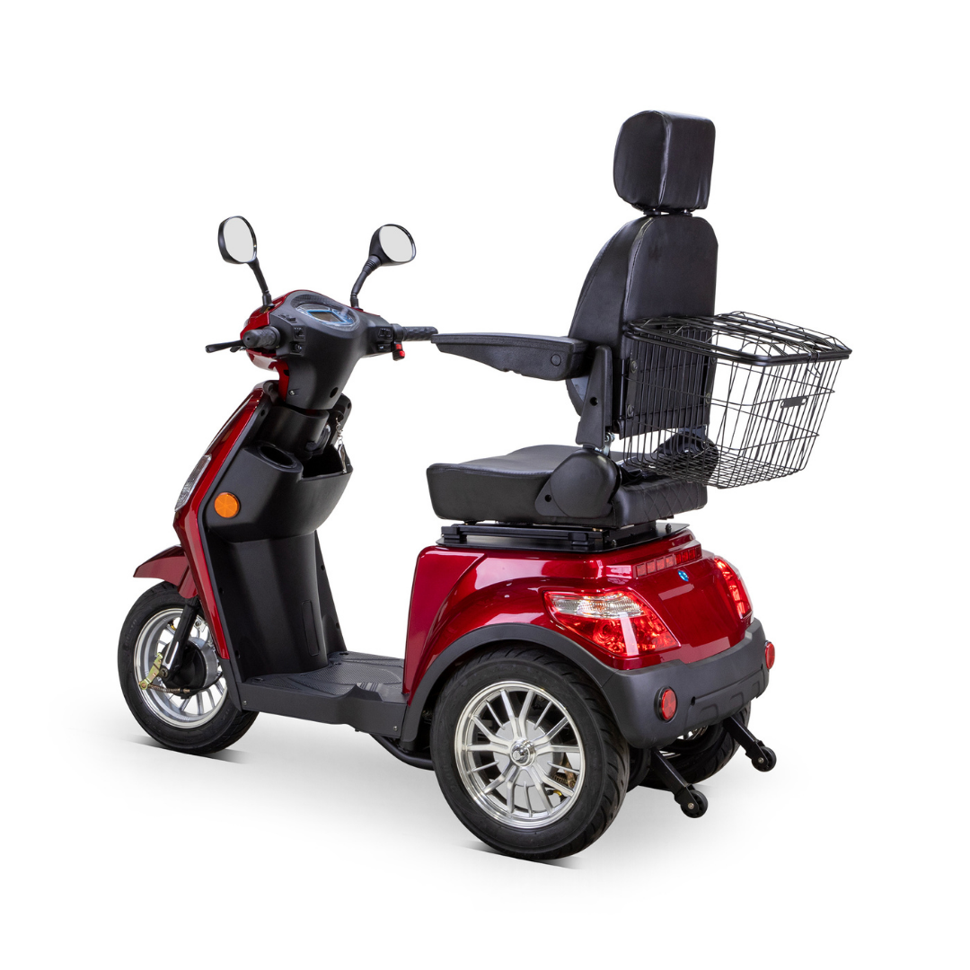The Bespoke Legacy Recreational 3-Wheel Scooter is a red mobility scooter featuring a padded seat with armrests and headrest, handlebars, a large rear metal basket, and a 600-watt motor for speeds up to 15 mph.