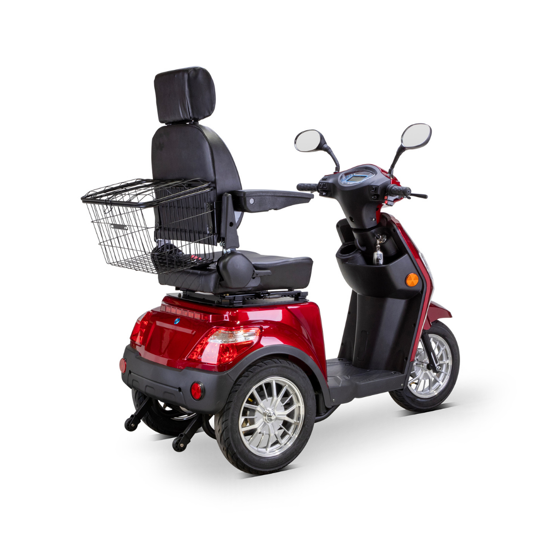 The Bespoke Legacy Recreational 3-Wheel Scooter is red, features a 600-watt motor, black cushioned seat with headrest and armrests, rearview mirrors, and a large wire basket on the back, displayed on a white background.