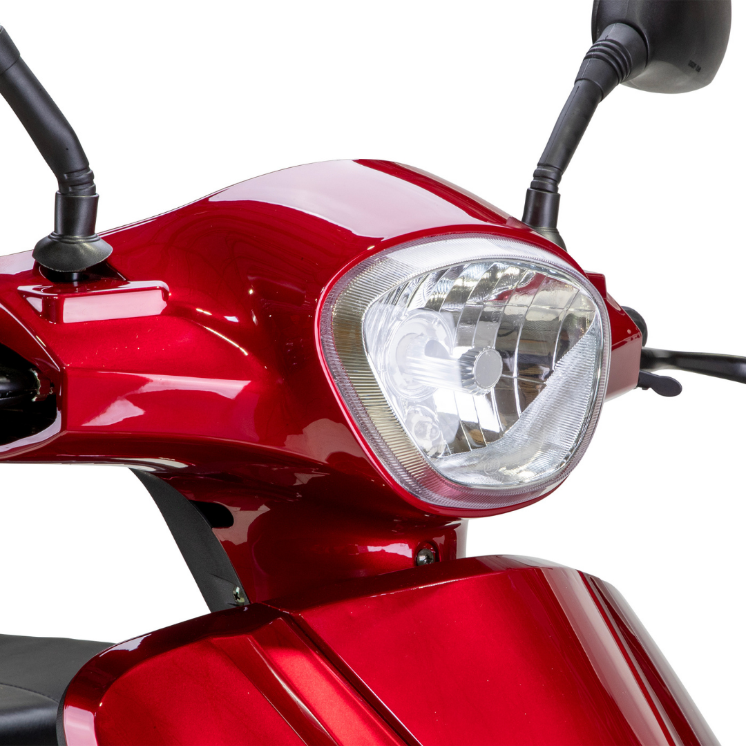 Close-up of the front section of a Bespoke Legacy Recreational 3-Wheel Scooter, featuring its shiny red finish, headlight, handlebars, and mirrors against a white background.