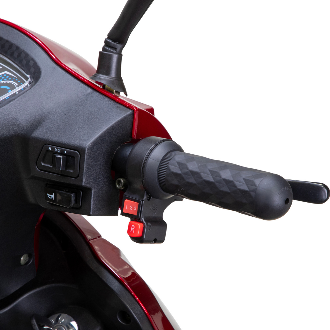 Close-up of a black rubber handlebar grip with control switches on the Bespoke Legacy Recreational 3-Wheel Scooter, including buttons labeled 1, 2, 3, and R for speed and reverse, plus electric lighting switches near the dashboard display.