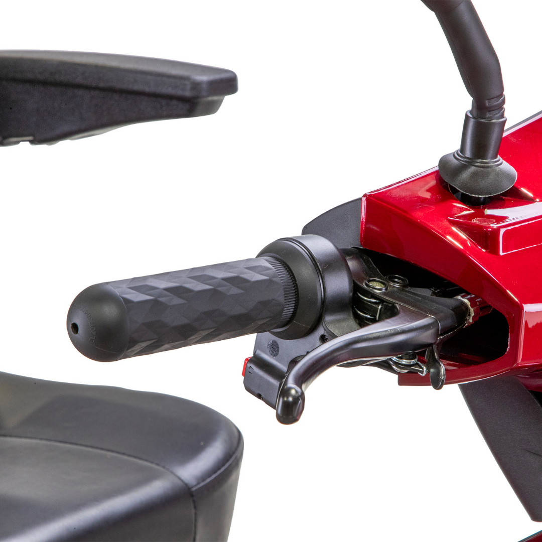 Close-up of a textured black handlebar grip and brake lever on a Bespoke Legacy Recreational 3-Wheel Scooter, with part of a black seat and armrest visible against a white background.