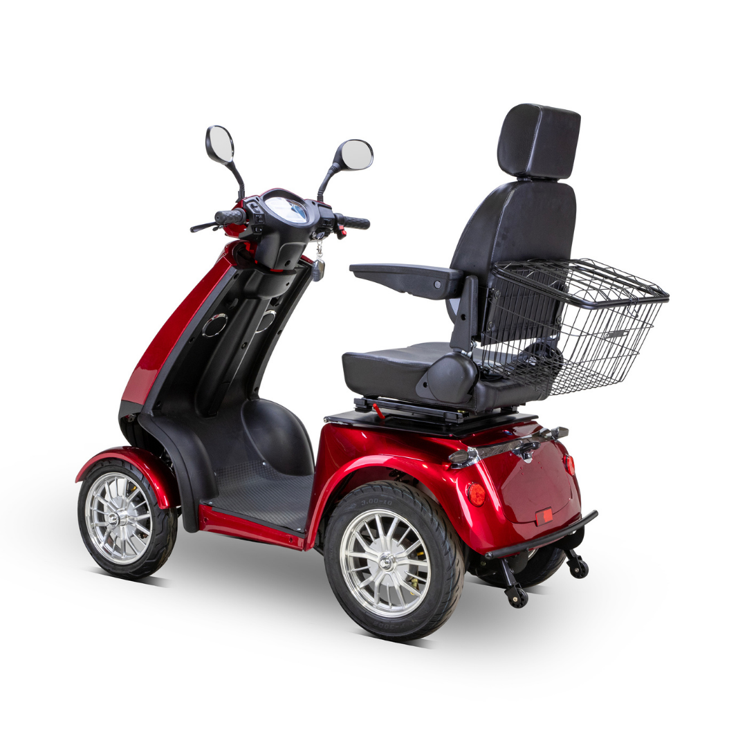 The Bespoke Platinum Recreational 4-Wheel Scooter with Electric Brake Assist is a red scooter with padded seat, headrest, armrests, rearview mirrors, and rear wire basket, featuring a high-performance motor for smooth rides on any surface.