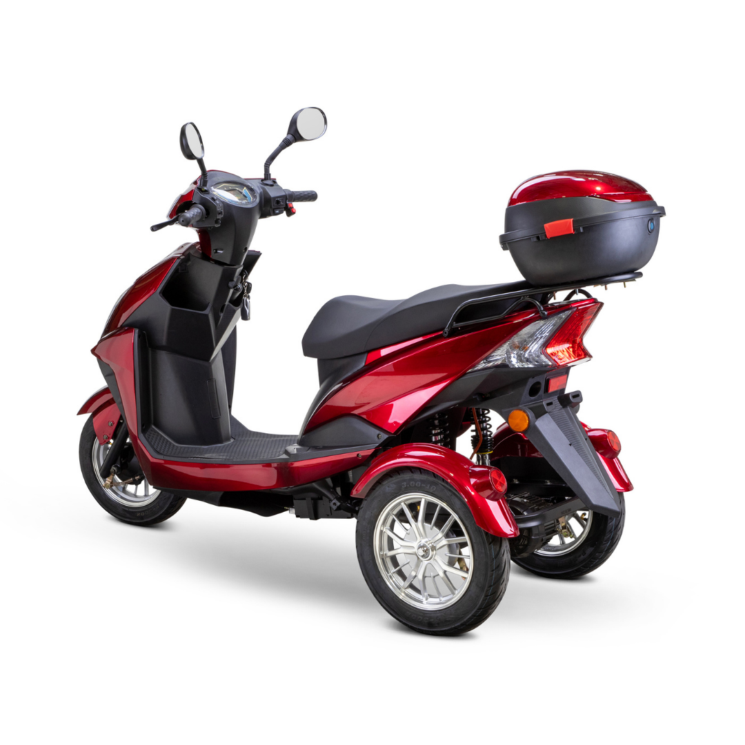 The Bespoke Regal Recreational 3-Wheel Scooter is a shiny red electric scooter with a 600-watt motor, black seat, rear storage box, mirrors, and silver alloy wheels, shown from a rear three-quarter angle on a white background.