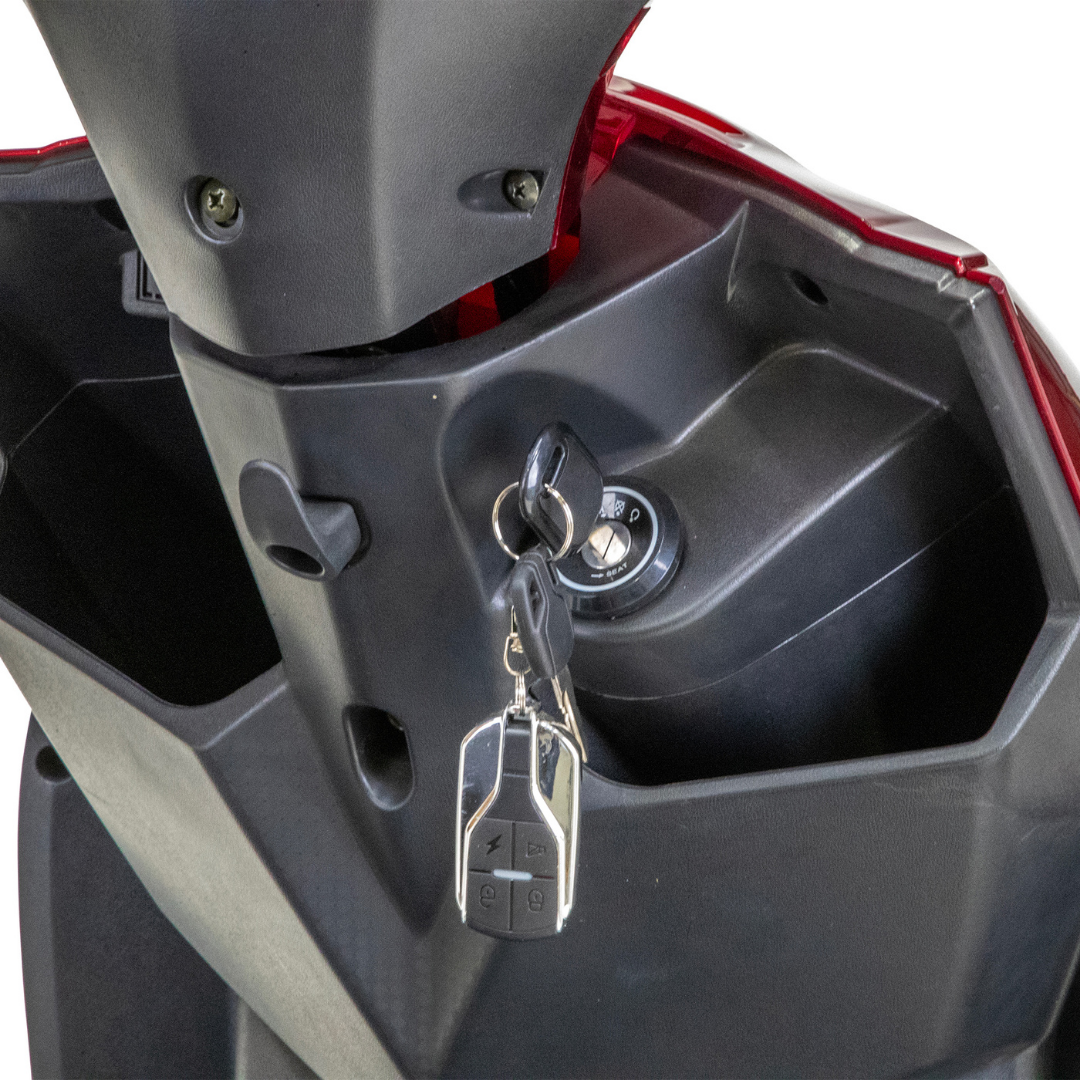 A close-up of the Bespoke Regal Recreational 3-Wheel Scooter’s ignition shows keys with a black fob by the sleek dashboard with a red accent; this model also features an advanced alarm system.