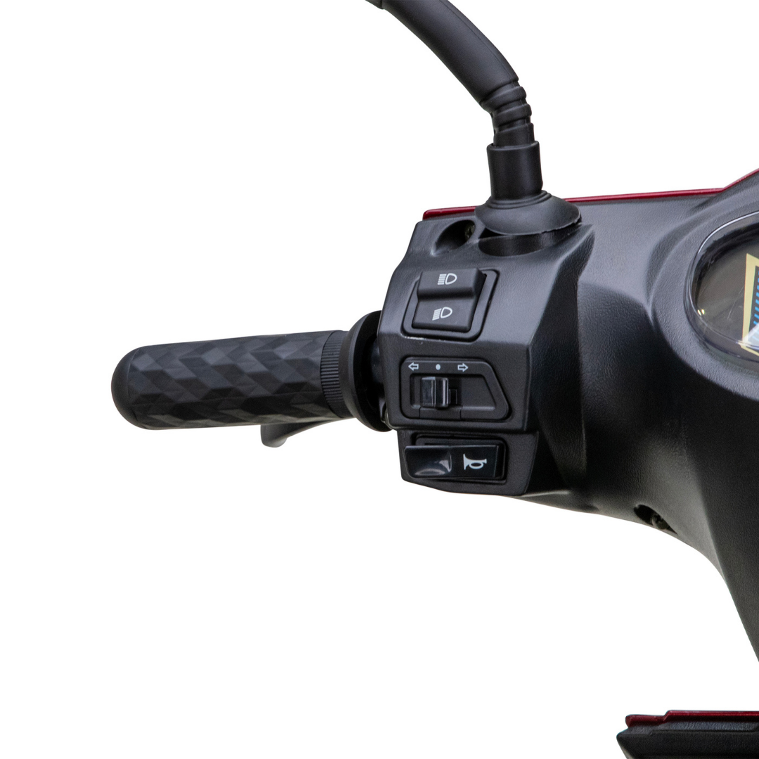 Close-up of the Bespoke Regal Recreational 3-Wheel Scooters left handlebar, displaying textured grip, control switches for headlights, indicators, and horn, plus a glimpse of the dashboard and its advanced alarm system for enhanced security.