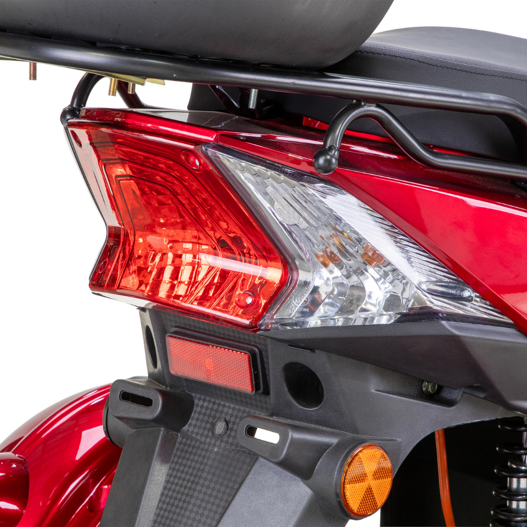 Close-up of the rear section of the Bespoke Regal Recreational 3-Wheel Scooter in red, highlighting its tail light, turn signal, partial seat, rear cargo carrier, and advanced alarm system against a white background.