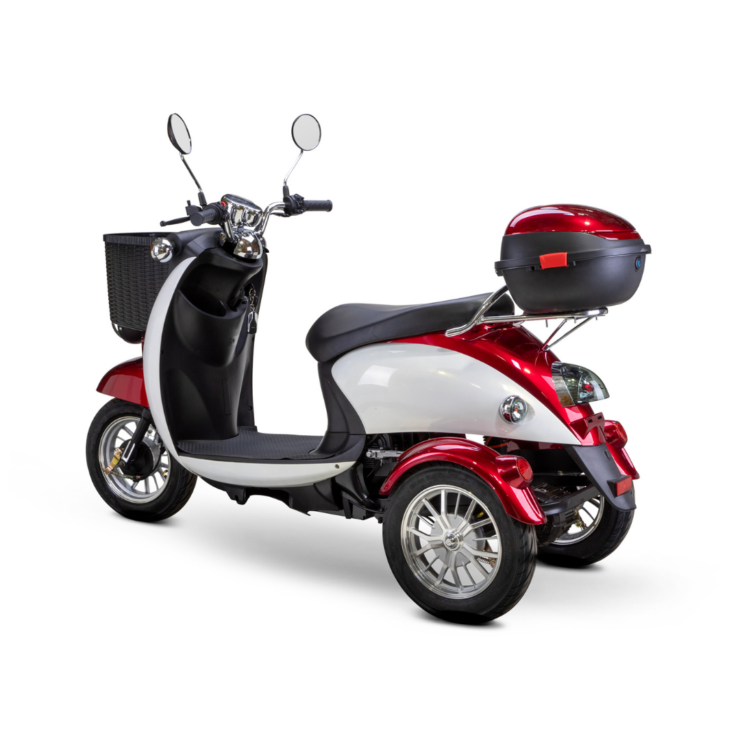 The Bespoke Supreme Euro-Style Recreational 3-Wheel Scooter with Electric Brake Assist, in red and white, has a 600-watt motor, a black front basket, rear storage box, two mirrors, silver rims, shown from the back left on a white background.
