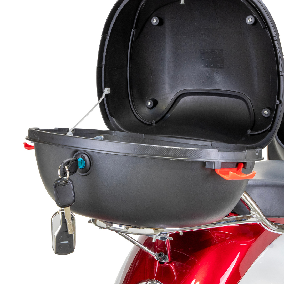 A black motorcycle top case with keys inserted sits open on a chrome rack at the rear of a red Bespoke Supreme Euro-Style Recreational 3-Wheel Scooter with Electric Brake Assist.