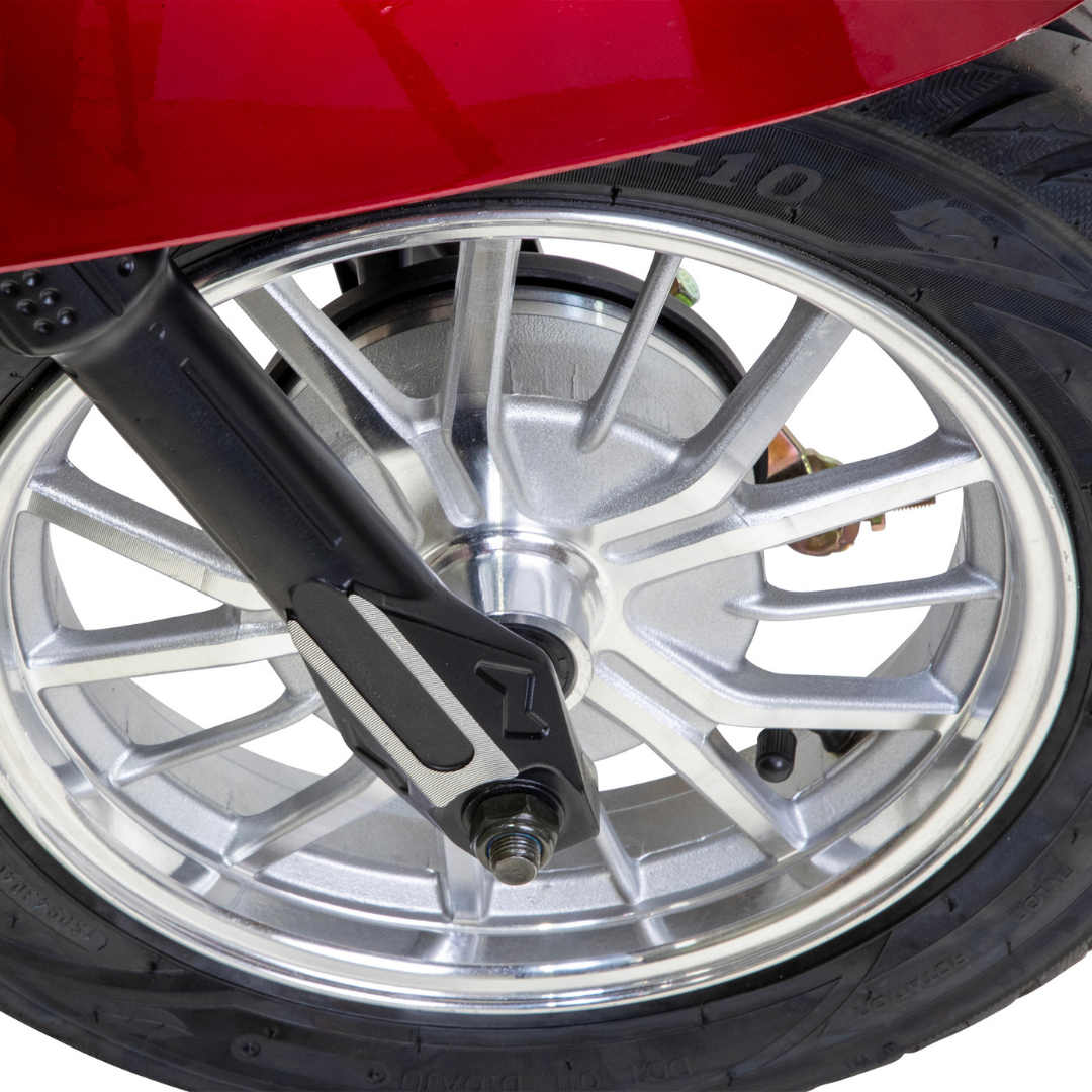 Close-up of a silver spoked wheel with black tire and part of a red fender from the Bespoke Supreme Euro-Style Recreational 3-Wheel Scooter with Electric Brake Assist, set against a white background.