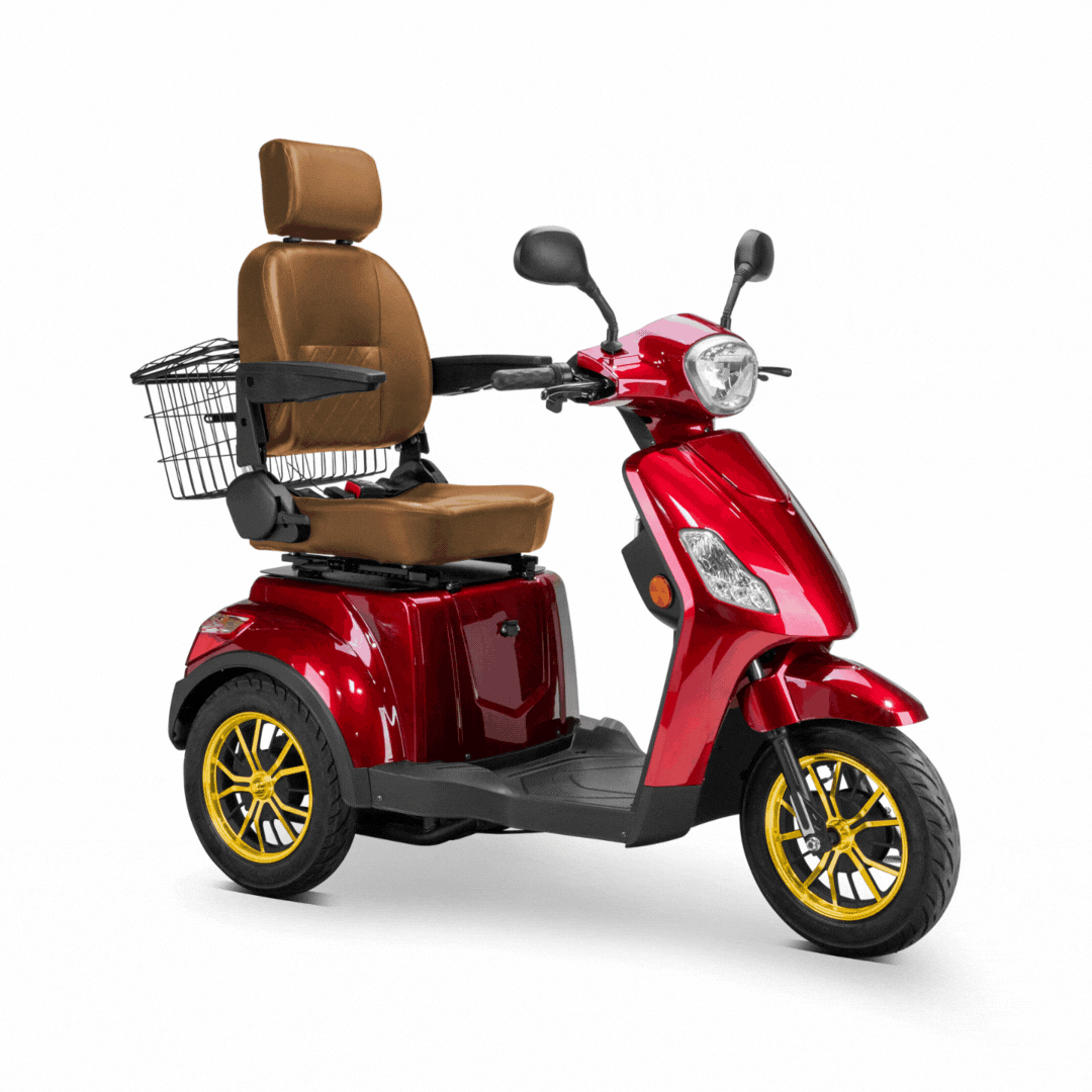 A red Bespoke Legacy Recreational 3-Wheel Scooter with electric brake assist features a padded brown seat, backrest, armrests, rear basket, and yellow-trimmed wheels. Seen from the front-left against a white background.