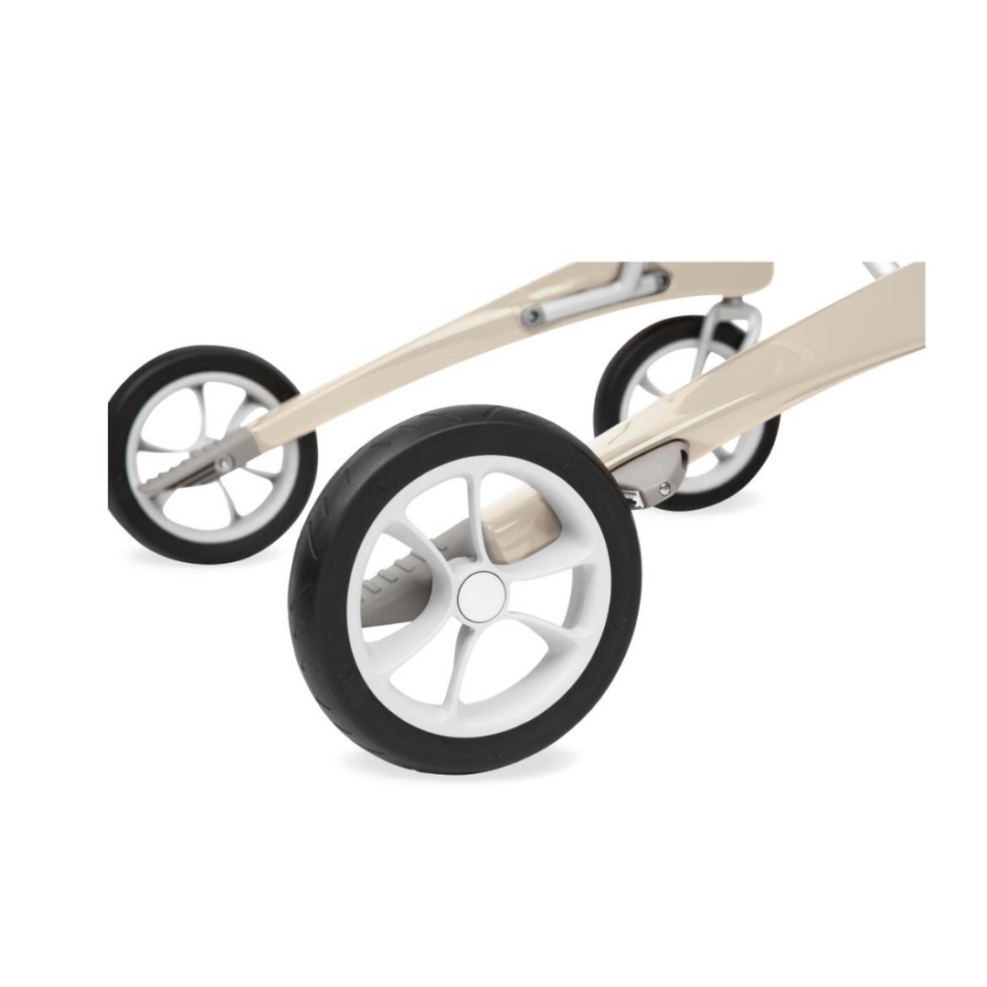 A close-up of the ByACRE Ultralight Carbon Fiber Rollator shows its sleek beige frame with two large, white-rimmed wheels and black tires. The carbon fiber frame is ultra-lightweight at 10.6 lbs, enhancing its modern design and allowing for effortless maneuvering on smooth surfaces.