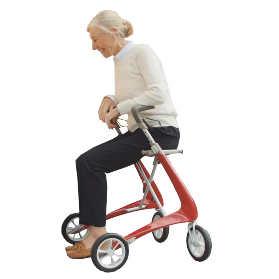 An elderly person with gray hair and a white sweater is leaning on a red ByACRE Ultralight Carbon Fiber Rollator (10.6 lbs), smiling and looking forward. Against a white background, they appear to be in motion or adjusting the walkers ergonomic handles.