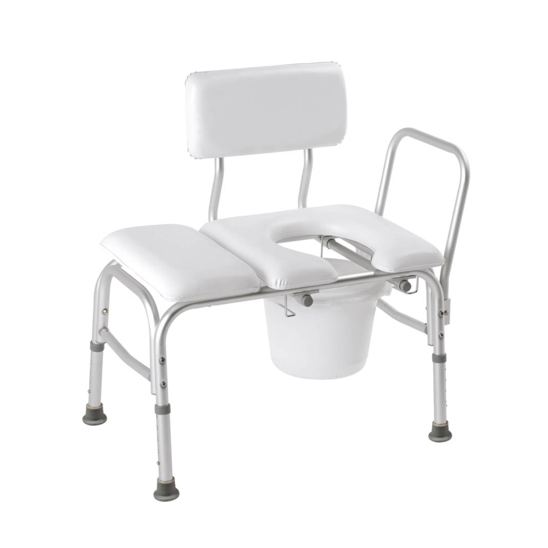 The Carex Deluxe Padded Transfer Bench with Commode Opening & Bucket is a white metal shower chair with backrest, armrest, and an open seat over a removable bucket—designed for accessible bathing and bedside commode use.