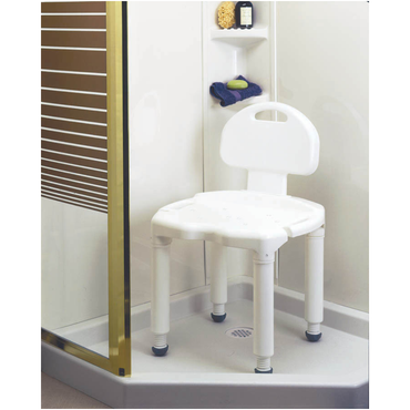 A Carex Bariatric Bath Seat and Shower Chair with Backrest is set in a corner shower with a glass door, while wall shelves nearby hold soap, a bottle, and a folded washcloth.