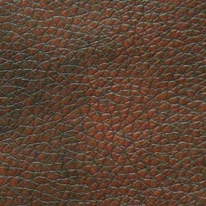 The detailed grain pattern in the close-up texture of brown leather with pebbled surface and natural creases evokes the luxurious feel of a Golden Tech PR766 Relaxer MaxiComfort Recliner With Lift Assist - Small.