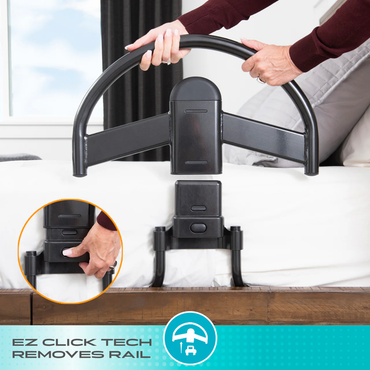 A person removes a black safety rail from a bed using the Stander Click-N-Go Bed Handle with Quick Release Button. An inset shows a close-up of a hand pressing the button to detach the rail. Text reads: QUICK RELEASE REMOVES RAIL.