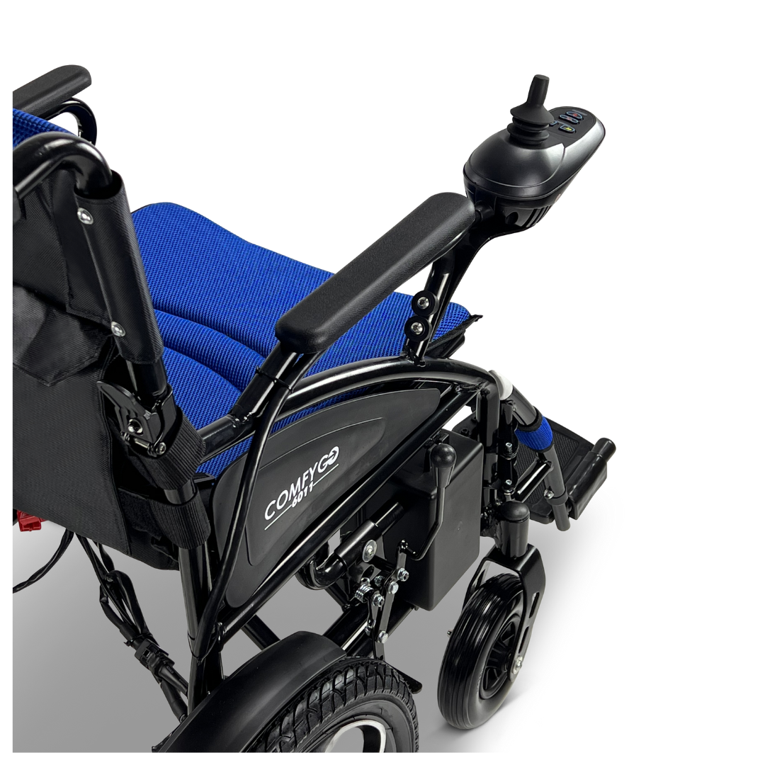 A close-up of the ComfyGO 6011 Folding Electric Wheelchair shows its black and blue design, featuring a joystick control on the armrest with padded cushions, a footrest, and Comfy Go branding on the frame against a plain white backdrop.