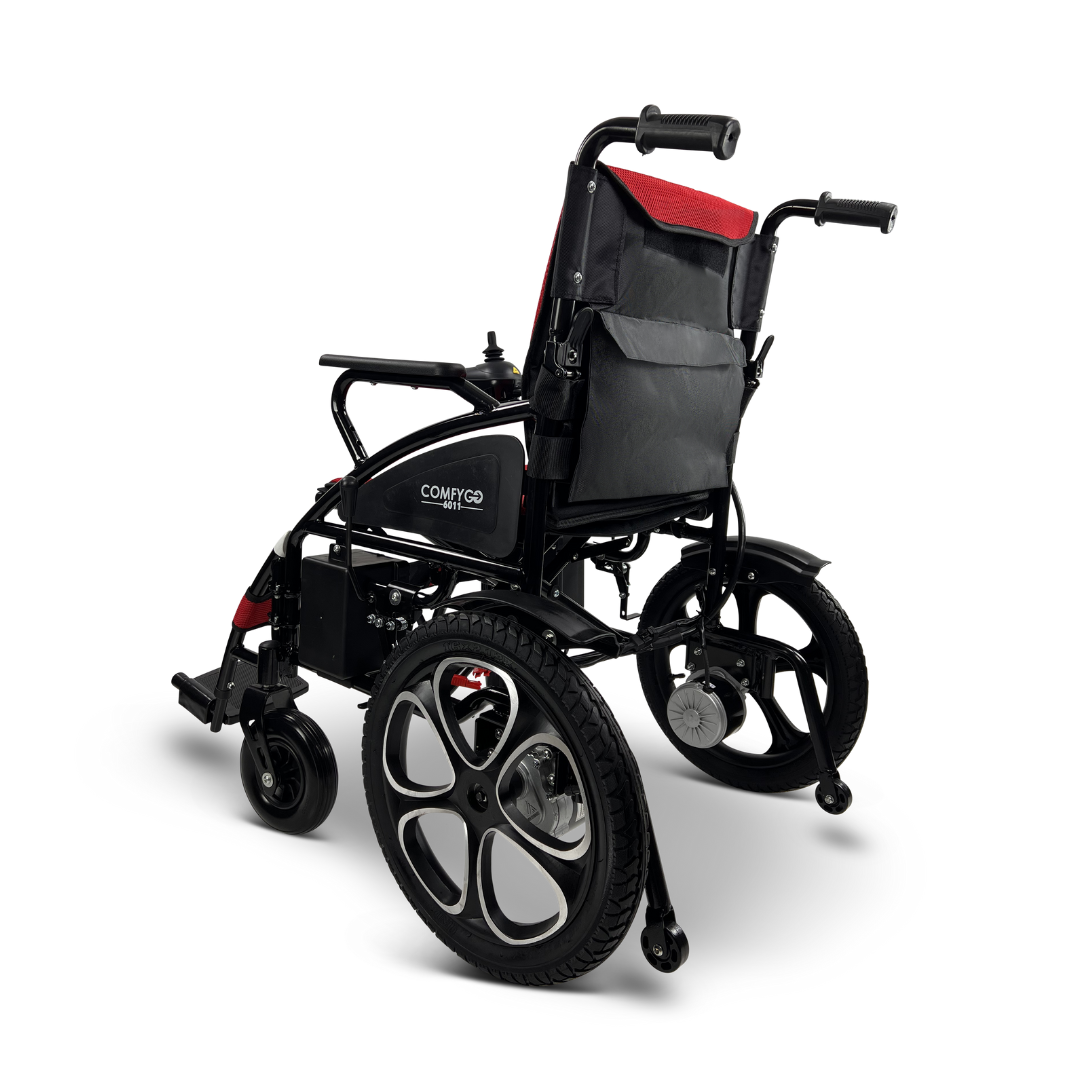 The ComfyGO 6011 Folding Electric Wheelchair, shown from the rear, boasts a lightweight design with large rear wheels, smaller front wheels, armrests, joystick control, and a cushioned backrest. Its sleek black and red look is portable and FAA approved.