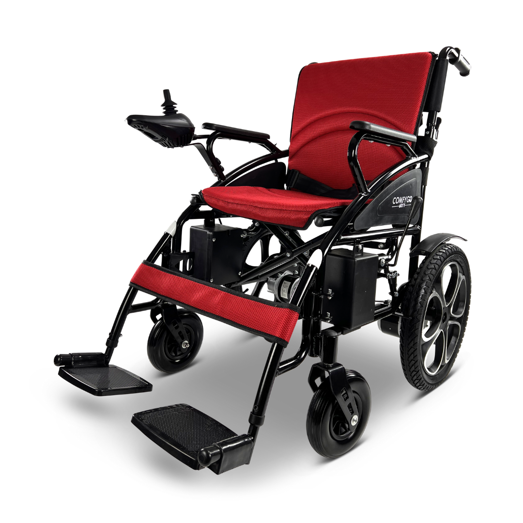 The ComfyGO 6011 Folding Electric Wheelchair in red and black is lightweight, foldable, and features a right armrest joystick, footrests, large rear wheels, and a cushioned seat and backrest for comfort.
