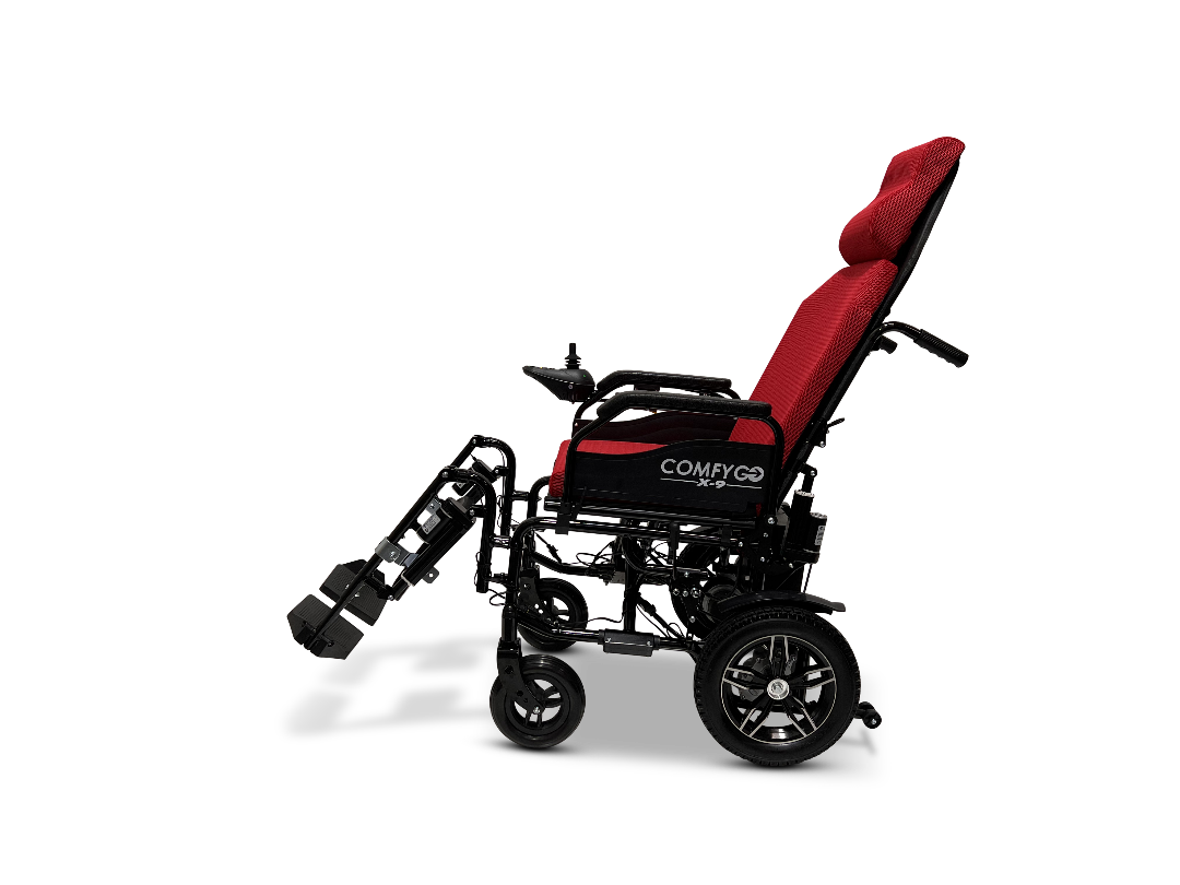 The ComfyGo X-9 Remote Controlled Powerchair features a red seat cushion, a black frame, adjustable footrests and armrests, and larger rear wheels for stability. This modern design ensures enhanced comfort and mobility while providing both style and convenience for users.