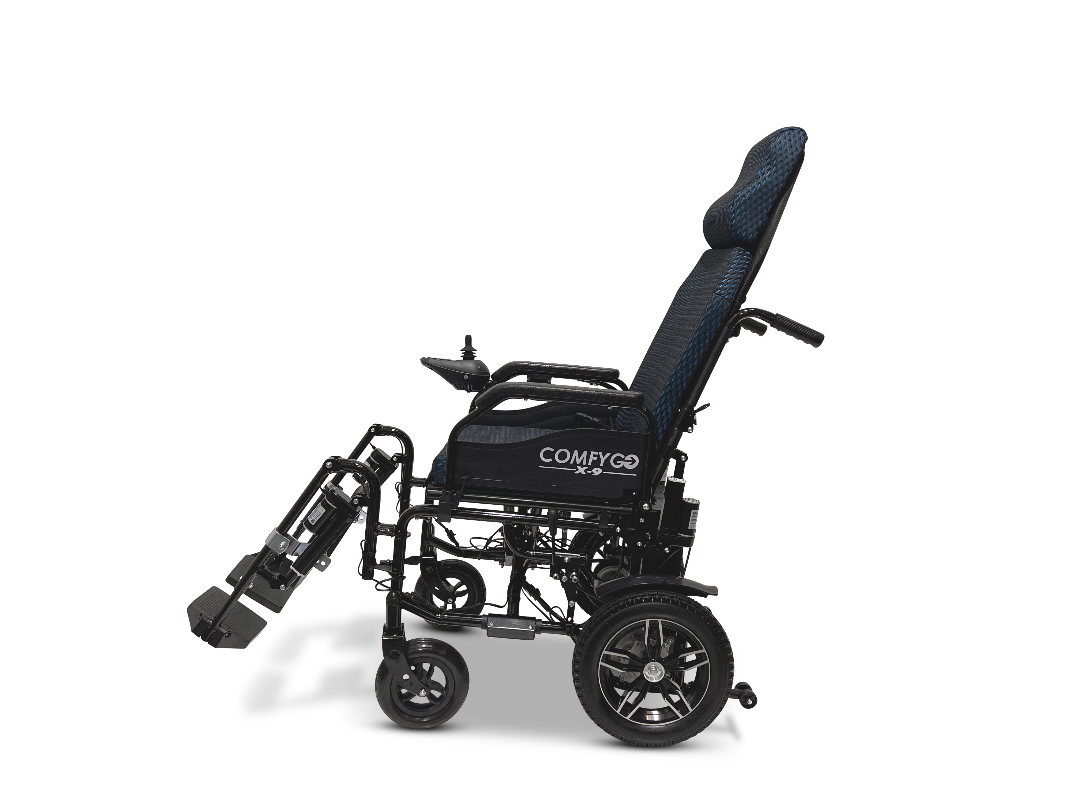 The side view of the ComfyGo X-9 Remote Controlled Powerchair showcases its ultimate mobility features, including black cushioning, a sleek metal frame, small front wheels, larger rear wheels, and adjustable footrests for enhanced comfort and effortless movement.