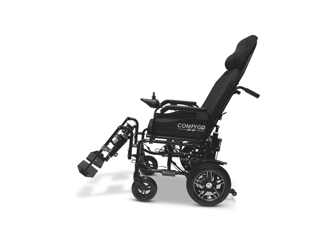 The ComfyGo X-9 Remote Controlled Power Chair boasts a sleek black design with a raised, reclining padded backrest, adjustable armrests, and elevated leg support. This advanced mobility solution features four wheels and prominently displays the ComfyGO brand on its side.