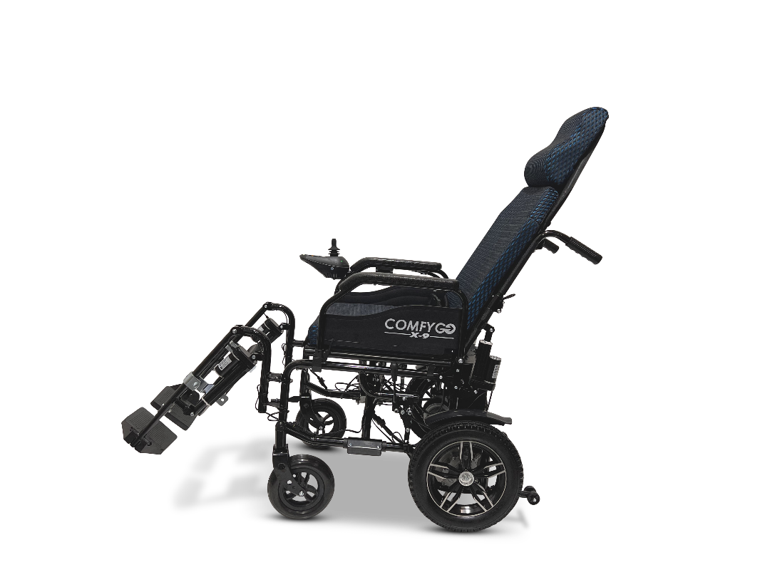 The ComfyGo X-9 Remote Controlled Powerchair - Automatic Reclining offers superior mobility with a reclined position, adjustable footrest, black frame, and cushioned seat/backrest. Its sleek design includes a small rear wheel and larger front wheel for modern styling.