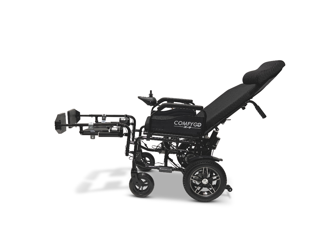 The side view of the black ComfyGo X-9 remote-controlled powerchair showcases ultimate maneuverability with adjustable seat and backrest, footrests, and rear/front wheels. The automatic reclining seat offers maximum comfort.