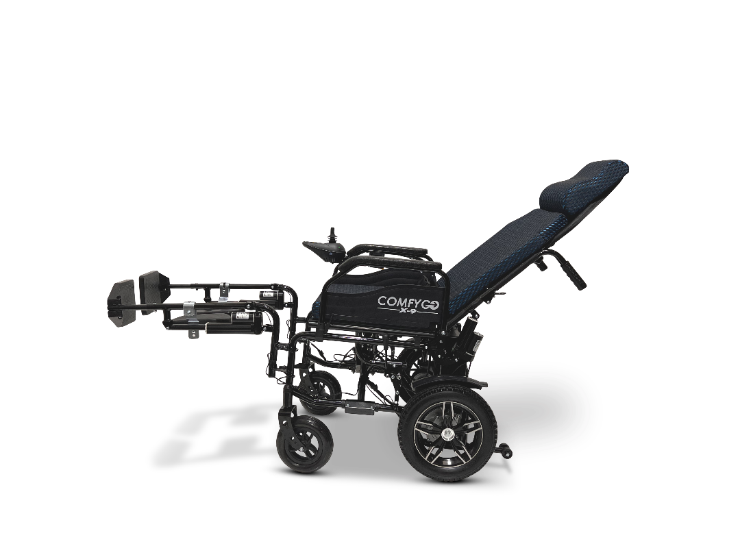 A side view of the sleek black ComfyGo X-9 Remote Controlled Powerchair showcases its reclined backrest and extended footrests. The textured dark fabric seat bears the ComfyGo branding. This four-wheel mobility solution offers remote-controlled, adjustable design for optimal comfort.