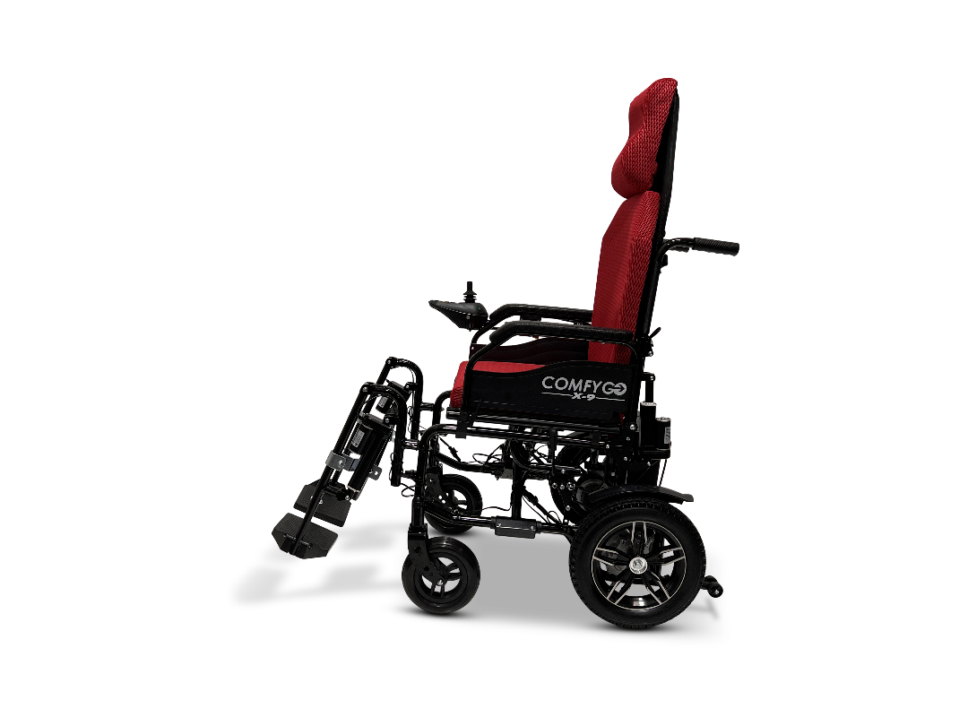 Side view of a black and red ComfyGo X-9 Powerchair with COMFYGO branding. It features large rear wheels, smaller front wheels, padded headrest, and an elevated footrest for comfort and ease.