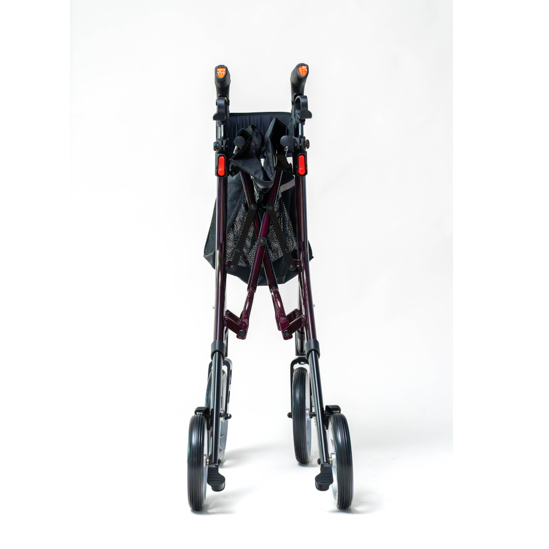 The Compass Health Ascent Premium Euro-Style Rollator, seen from the front against a white background, is a foldable burgundy walker with a lightweight aluminum frame and four wheels. It includes black handles and a mesh storage bag, offering excellent mobility support.