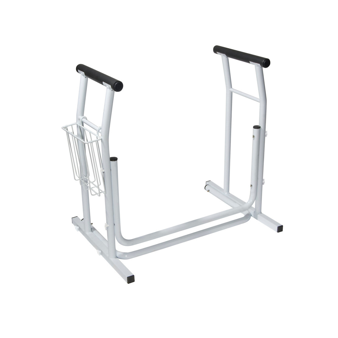 A white metal bedside assist rail with black foam handles, wire pocket, and solid base offers support for getting in and out of bed—perfect to pair with the Drive Free-standing Toilet Safety Rail for enhanced senior safety.