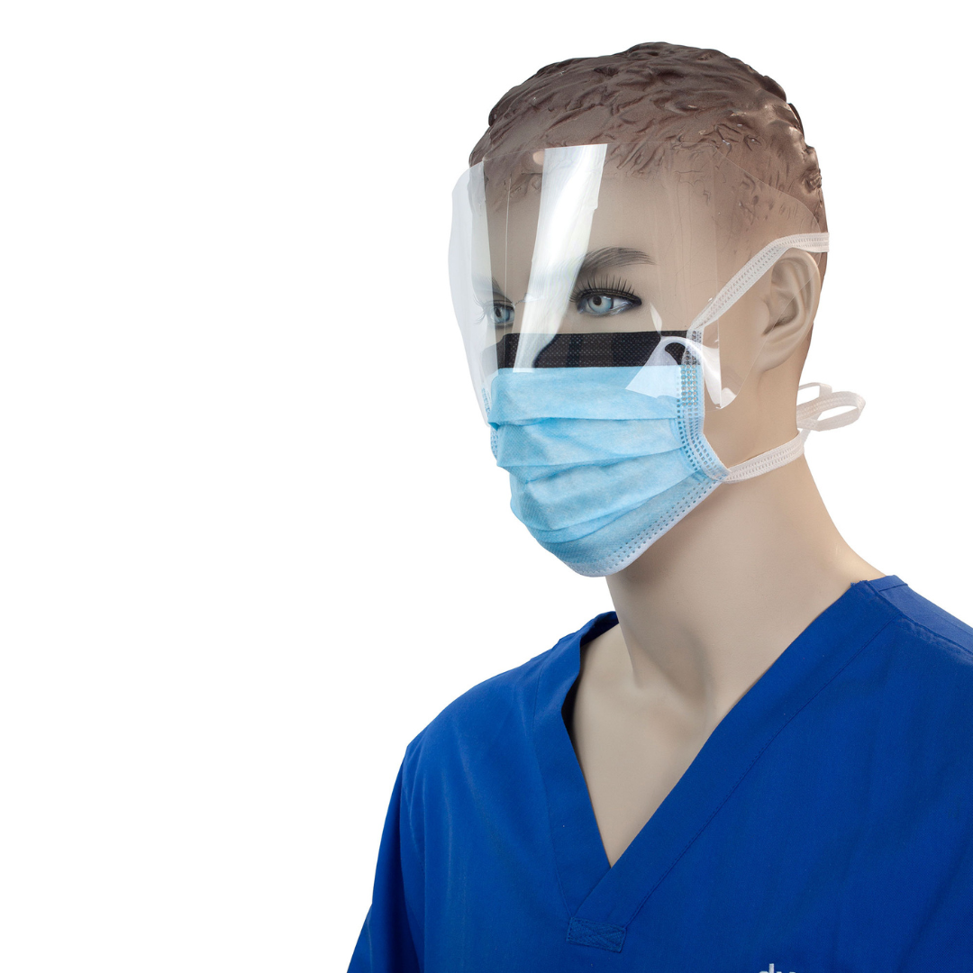 A mannequin in blue medical scrubs wears a Dynarex Surgical Face Mask w/ Ties and a clear face shield, demonstrating PPE for healthcare. Specs and videos available. White background.